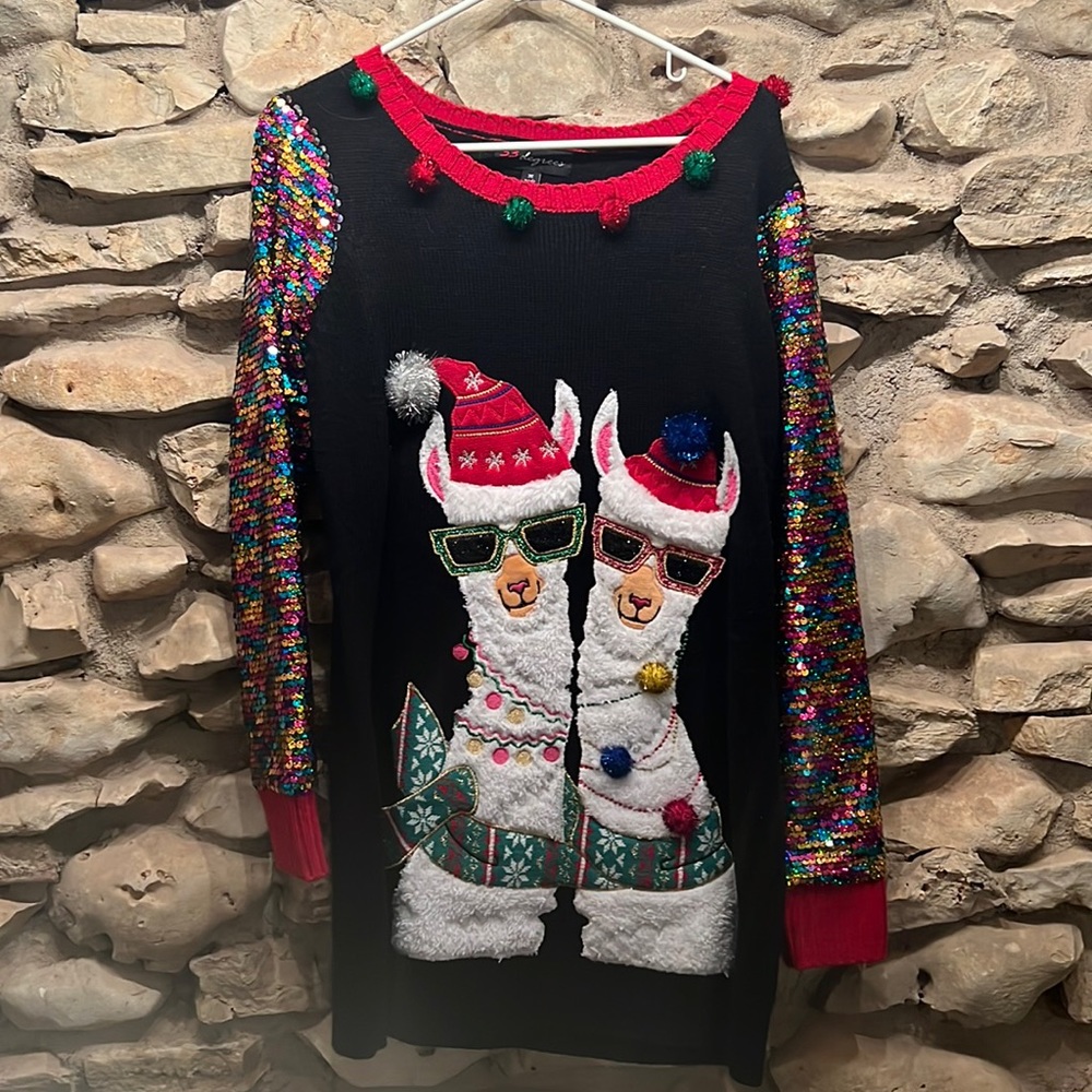 Ugly Christmas sweater with llamas and sequin sleeved detail.